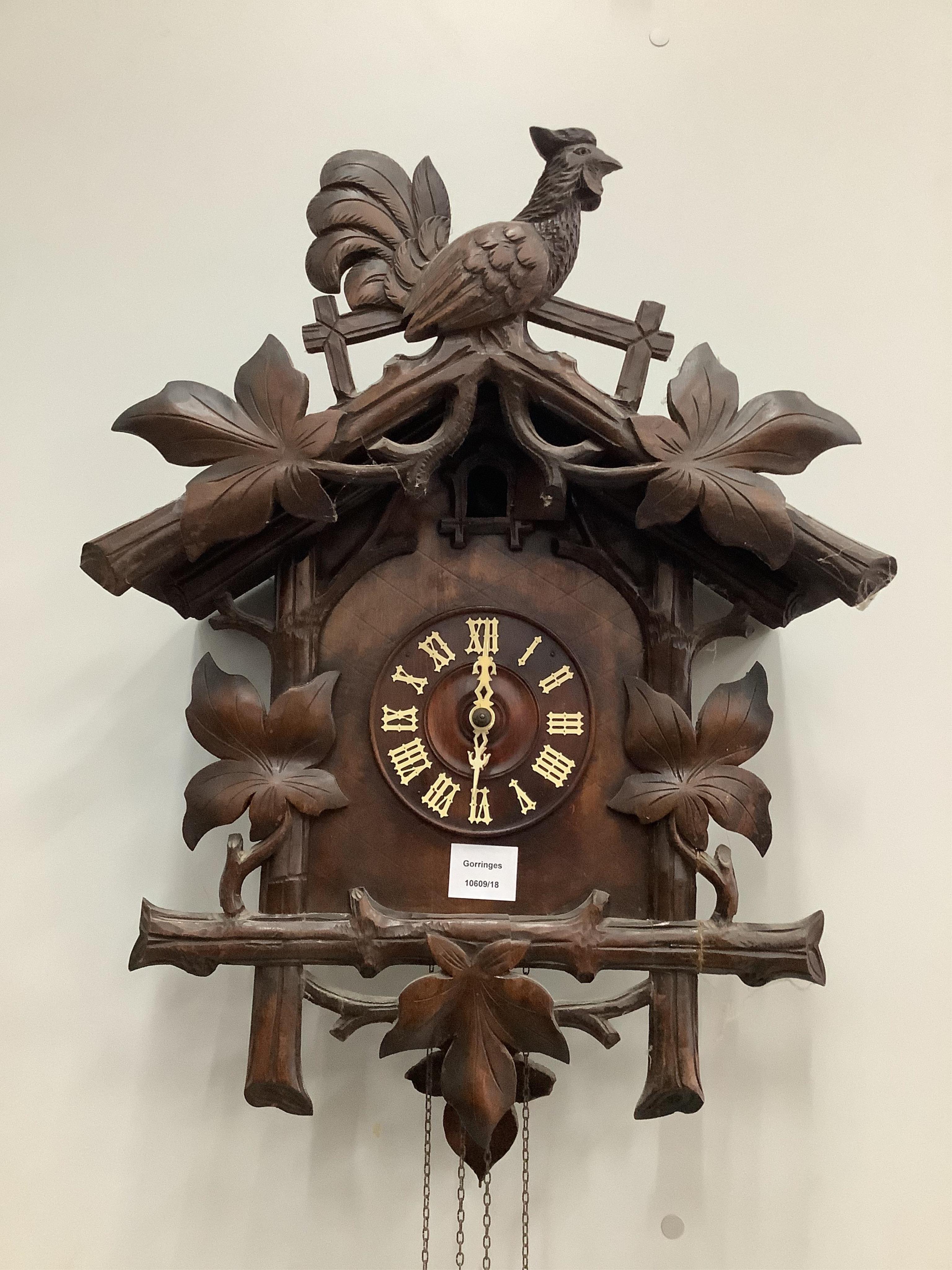 A Black Forest carved cuckoo clock, height 58cm. Condition - fair